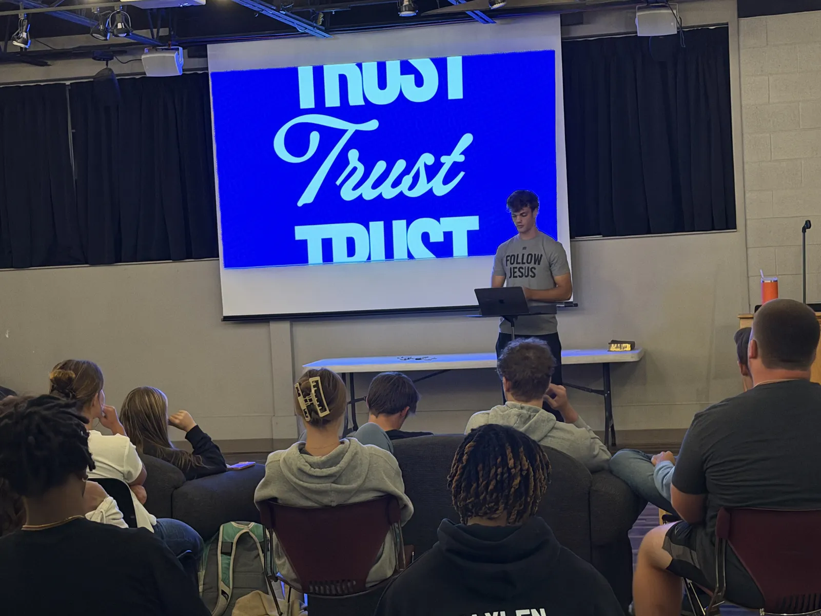 Students listening to a speaker at an FCA gathering